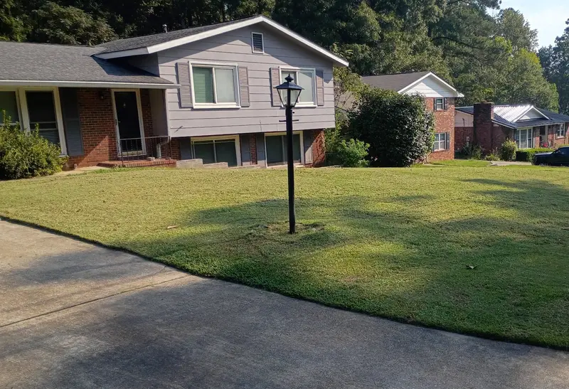 Front lawn mowed and edged along the driveway of a split-level home